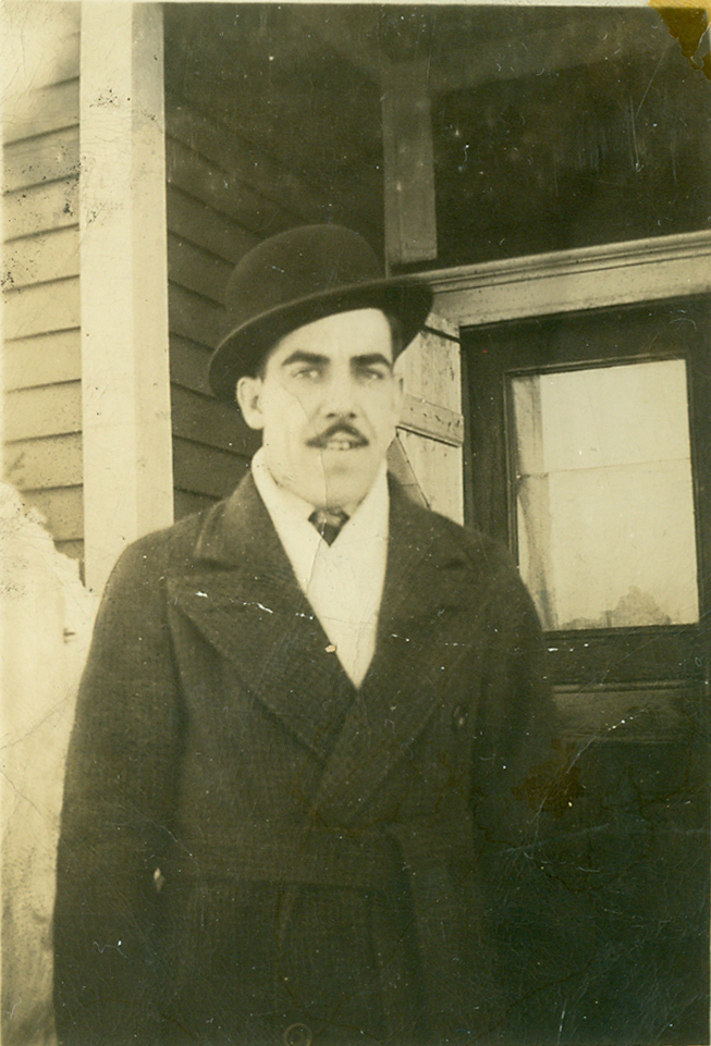 Elmer Terrio standing in front of his parents' home in Joggins