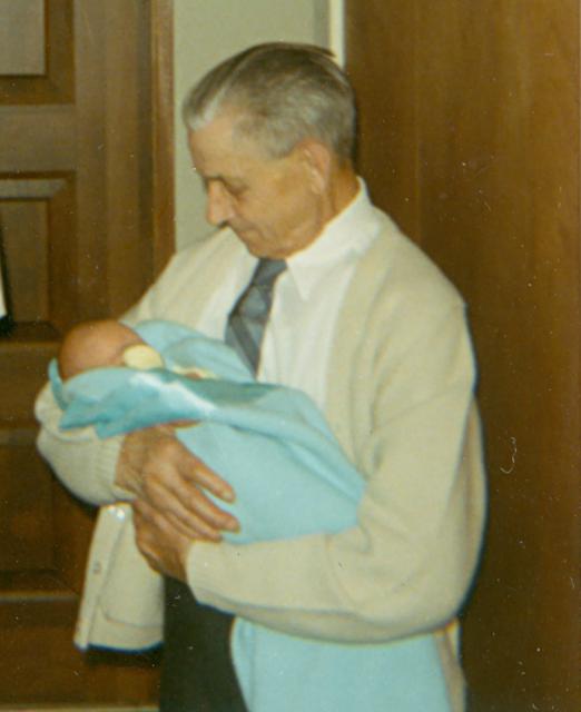 Lawrence Michaud holding one of his great-grandsons